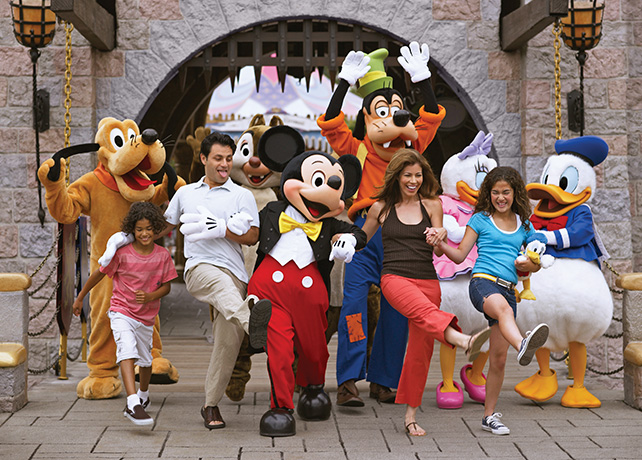 family walking with disney characters