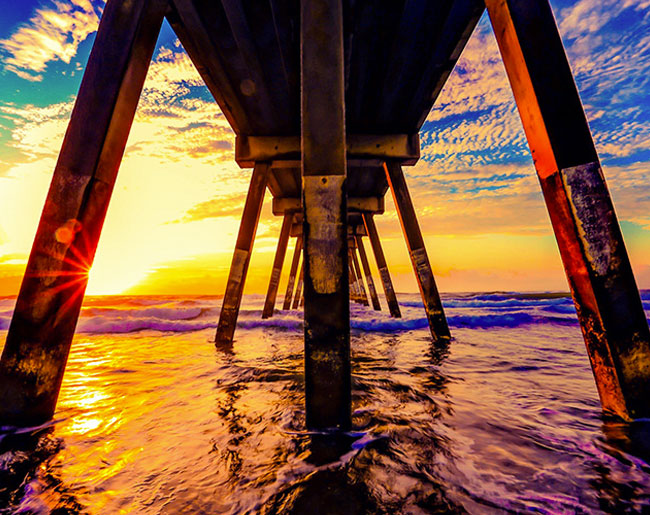 View from under a pier at sunset