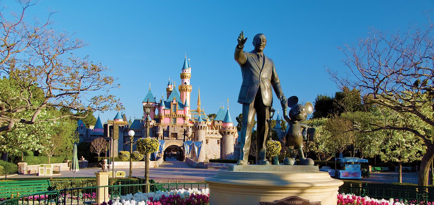  Image of Cinderella's Castle at Disneyland and a statue of Walt Disney and Mickey Mouse