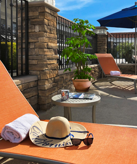 orange lounge chair with sun hat and glasses at tropicana inn & Suites